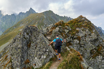 Hiker with backpack in the mountains