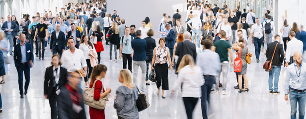 trade fair visitors walking in a clean futuristic corridor