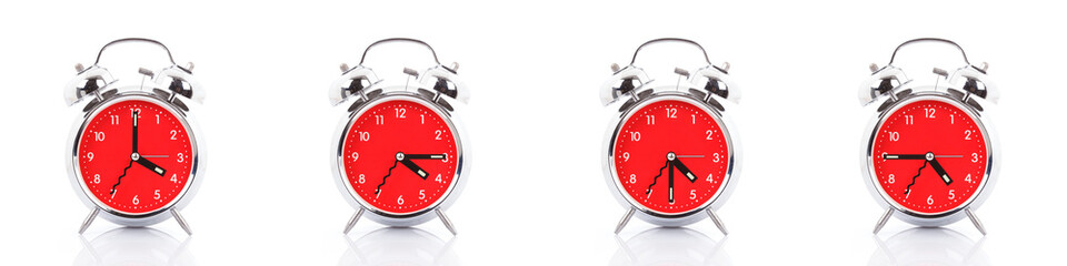 GROUP OF RED CLOCKS ON WHITE BACKGROUND.