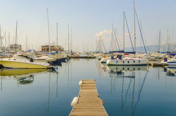 Sailboats, yachts and pier at marina in the Gulf of Trieste.