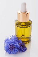 Naklejka premium essential oil of cornflower on a white background