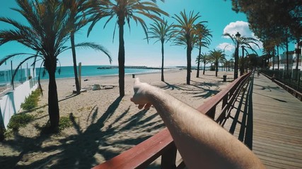 4K 25fps Hand pointing on palm treeas
