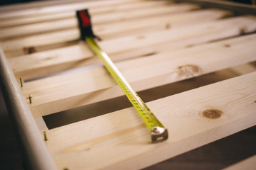 close up construction roulette on the wooden bed, furniture Assembly