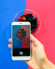 Blueberry and raspberry bowl on colorful background