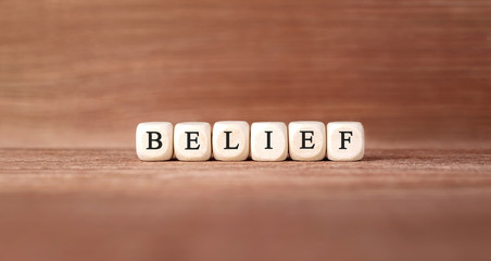 Word BELIEF made with wood building blocks