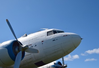 Fototapeta na wymiar front end of an historic aircraft the DC-3, blue sky in the background 
