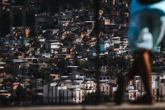 Man looking over the favela of Complexo do alemão in Rio de Janeiro