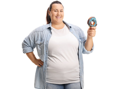 Smiling overweight woman holding a donut