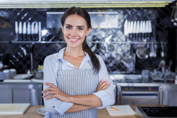 Beauty. Pretty pleasant lady smiling while posing in the kitchen