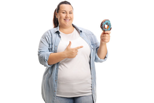 Overweight woman holding a donut and pointing