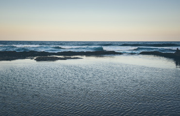 sea and sky, calm ocean, sunset over ocean, shades of blue, 