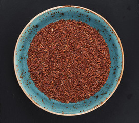 uncooked red rice on a plate