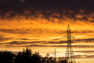 Fototapeta premium power lines against the backdrop of a bright sunset