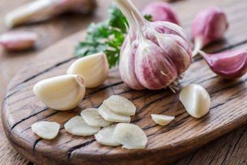 Garlic bulb and garlic cloves  on the wooden table.