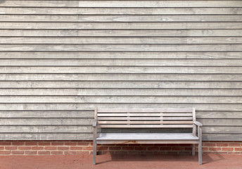 Wooden wall with park bench