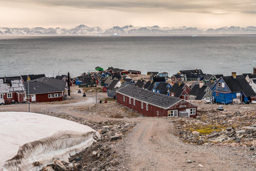 settlement of Ittoqqortoormiit with colorful houses, eastern Greenland at the entrance to the Scoresby Sound fjords - obrazy, fototapety, plakaty