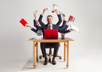 businessman with many hands in elegant suit working and holding office tools. Isolated over white background. Concept of busy