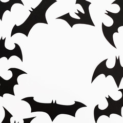 Frame of Halloween paper black bats on white background. Flat lay, top view.