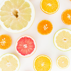 Citrus fruit pattern of lemon, orange, grapefruit, sweetie and pomelo on white background. Flat lay, top view.