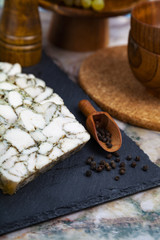 Chicken roll on a black plate.