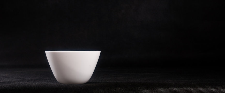 A white tureen on a black background