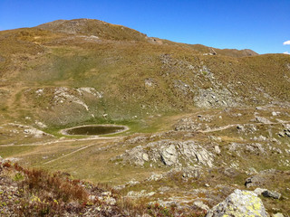Fototapeta na wymiar Panoramic view of a path that crosses the high pastures at the Sempione pass in Switzerland.