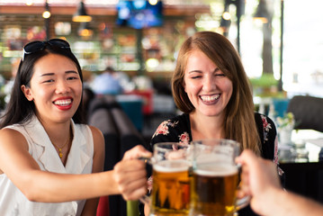 Friends drinking beer in the bar