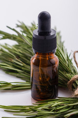 Rosemary essential oil on a white background