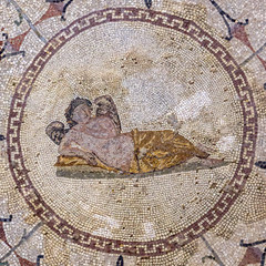 Floor mosaic of colored stones with the god of sleep Hypnos - young man with wings, lying on pillow, museum "Roman mosaics", Risana, Boca-kotor bay, Montenegro