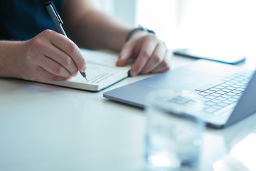 Close up shot businesswoman working on a laptop with her hands in the office with a modern design