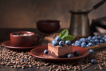 Chocolate cake with blueberries and mint .