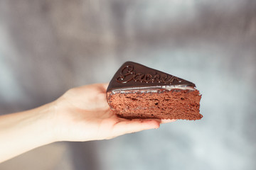 cake in the hands on a grey background