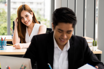Beautiful Businesswoman is looking at Businessman at the office.