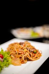 Spaghetti dish with beef and bean on the white disk