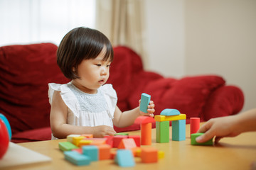 baby girl play toy blocks at home
