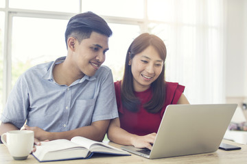 love couple talking and working on computer, husband and wife smile and use laptop in morning