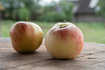 Three apples on the wooden table