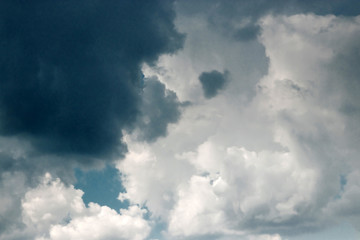 Fantastic, fluffy, white clouds against a blue sky. Rain clouds. The situation in the sky before the storm. copy space