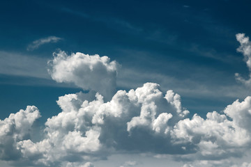 Fantastic, fluffy, white clouds against a blue sky. Rain clouds. The situation in the sky before the storm. copy space