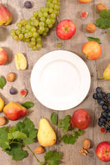Fototapeta na wymiar empty plate with fruit and vegetable around