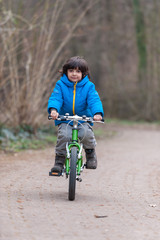 Little boy on bicycle in park
