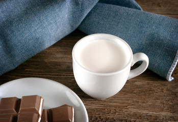 Milk in a mug, chocolate in a plate