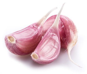 Unpeeled garlic cloves on white background.