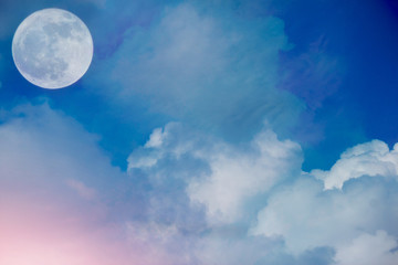 Fototapeta na wymiar Full moon with Beautiful clouds pink light in the sky.