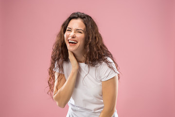 Happy business woman standing and smiling isolated on pink studio background. Beautiful female half-length portrait. Young emotional woman. The human emotions, facial expression concept. Front view.