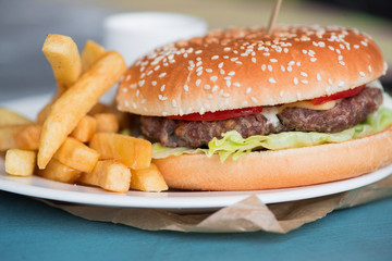 Macro photograph of a burger with French fries. Макро фотография бургера с картофелем фри.