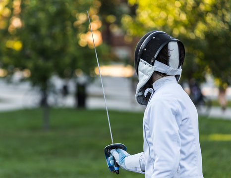 Close up of a fencing athlete in attacking position