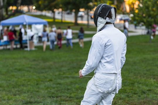 Fencing athlete on a green field