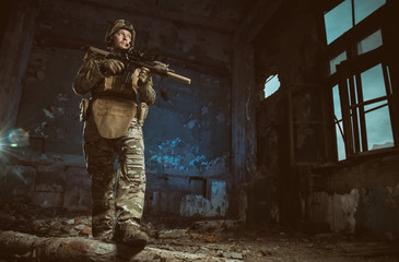 Fototapeta premium the people in uniform with weapons in the ruins