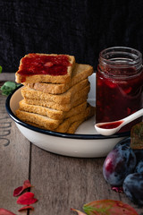 healthy breakfast: stack of rusks with homemade plum and hazelnuts jam